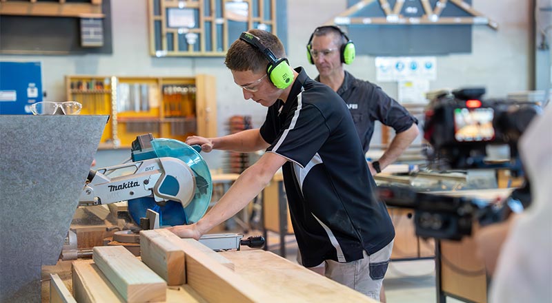 Kalan Markson working on his carpentry, with assistance from School-Based Apprenticeships and Traineeships tafe teacher